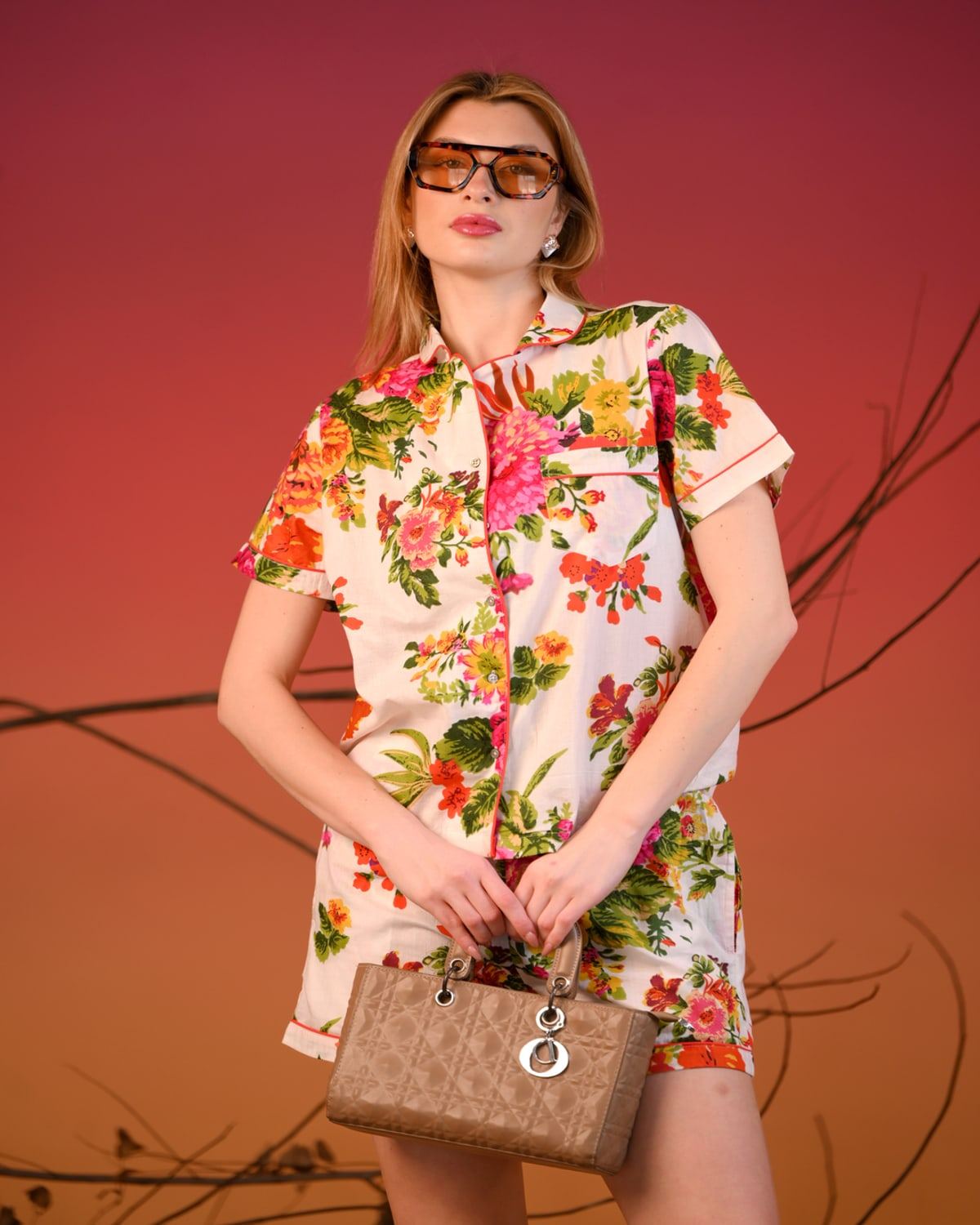 Ivory floral short-sleeve shirt and shorts co-ord against a sunset backdrop